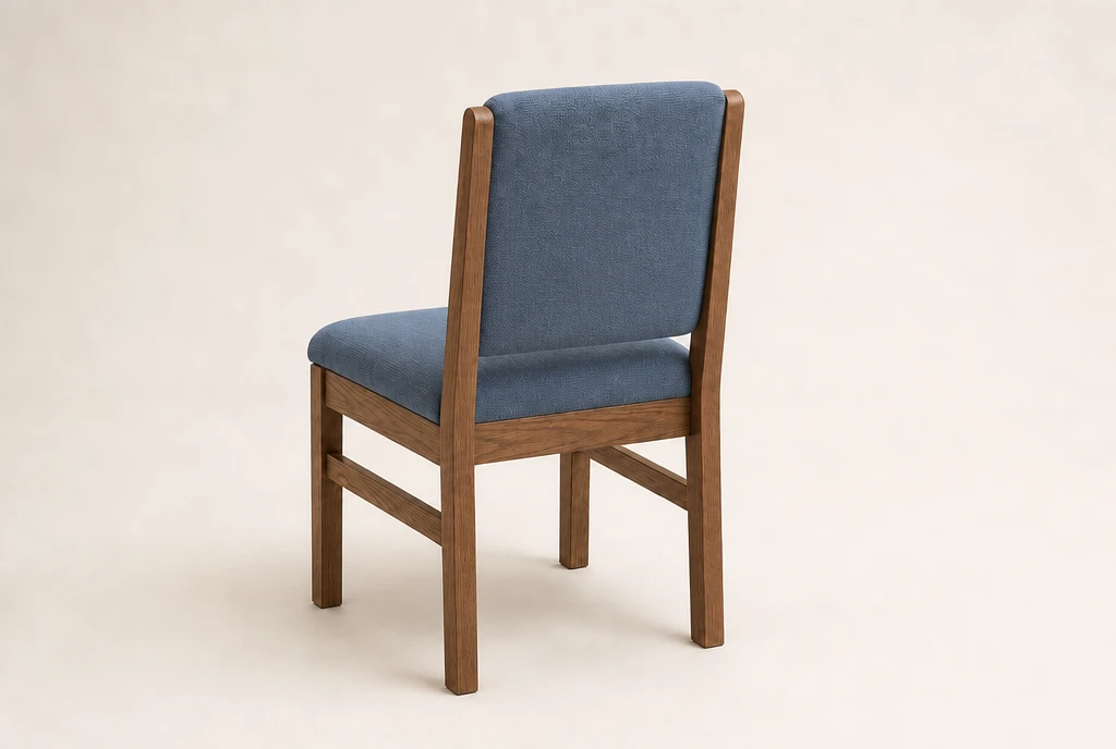 Warm pecan-toned hardwood church chair concept with muted French-blue woven upholstery and no rear book rack