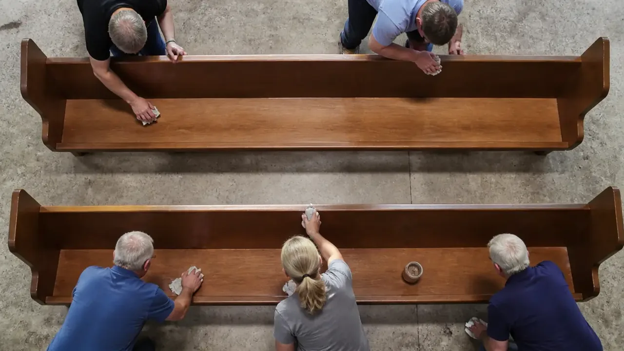 Overhead view of a row of wooden pews seen from above