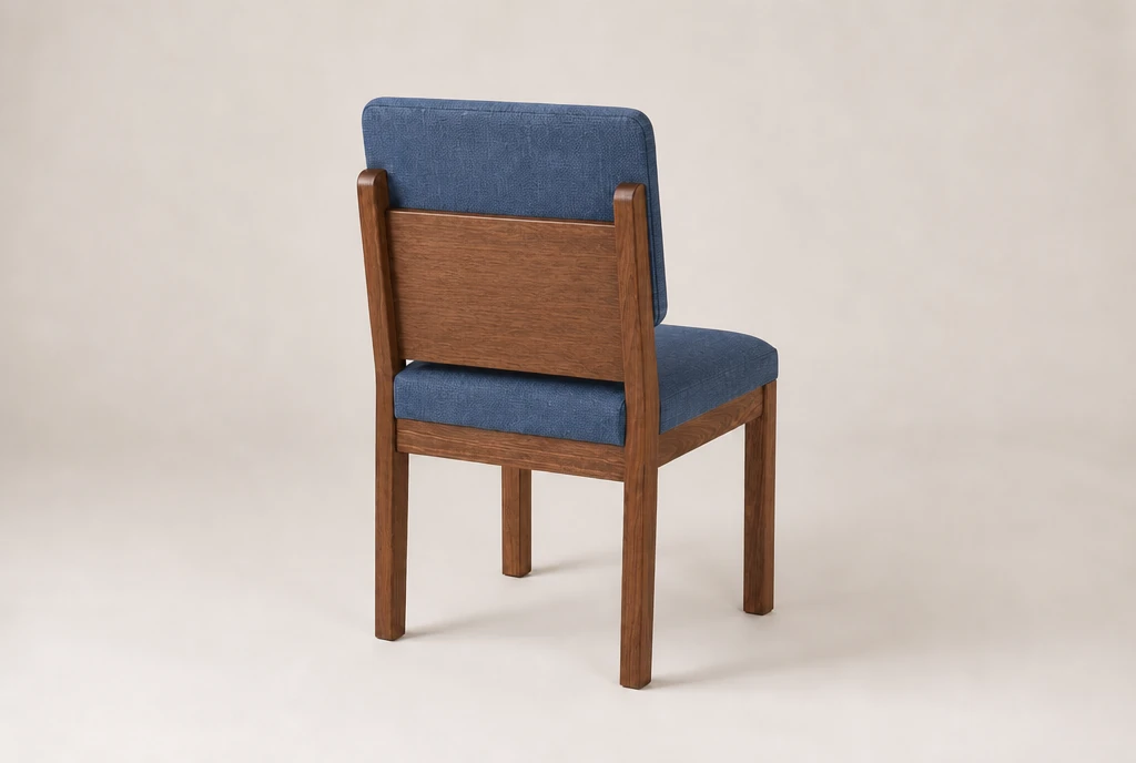 Warm walnut-stained hardwood church chair concept with muted denim-blue woven fabric and no rear book rack